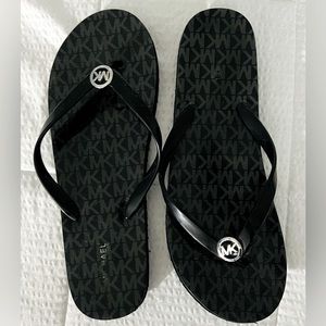 Michael Kors black flip flops. Silver monogram.